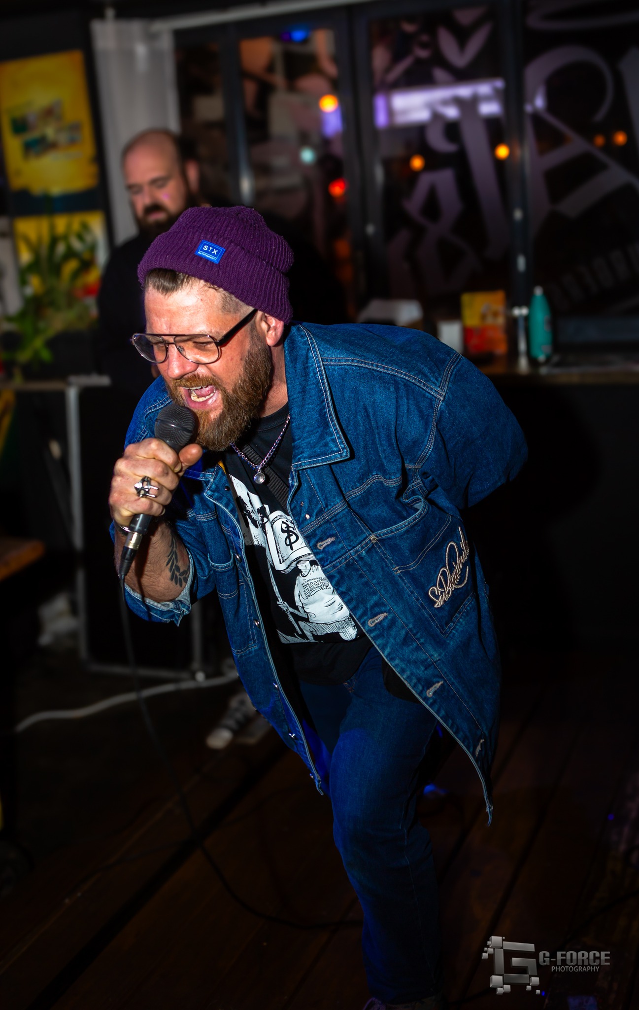 Live vocalist performing on stage with microphone